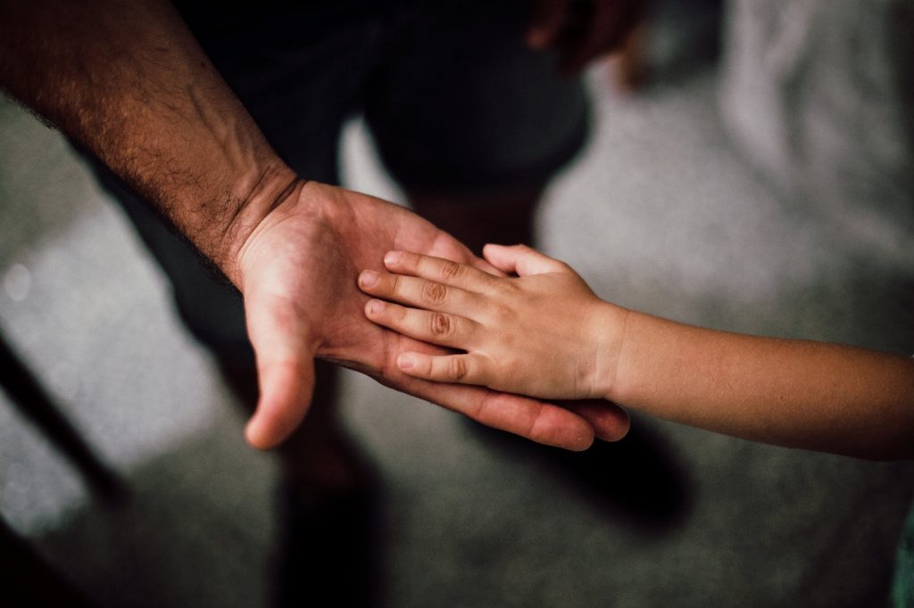 father and child s hands together